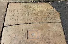 George Hodgson’s grave at the entrance to St Andrew’s Church, Dent. The Vampiric safeguarding measure is still apparent!