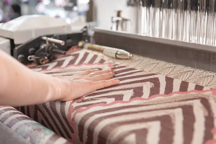 The Jacquard Project Hannah Robson operating the loom Fruit fabric on the loom - designed by Anna Ray and developed by Hannah Robson