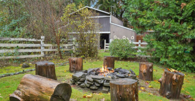 A small garden bonfire burning safely in a UK garden during autumn