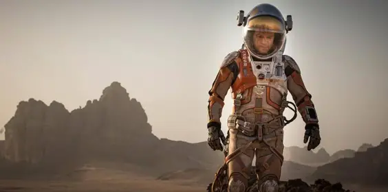 spaceman astronaut in full suit strides across the bleak martian landscape