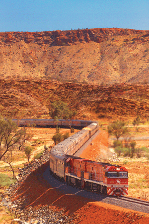 train snaking through desert mountains