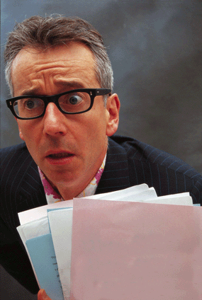 john hegley glasses with paper files looking anxious